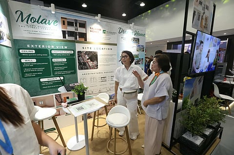 CDC President and CEO Atty. Agnes Devanadera checks one of the booths during the Real Estate Construct & Furnishing Expo at the SMX Convention Center in Clark.