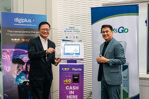 Danilo Ibarra, CEO of BTI Payments Philippines, and Jasper Vicencio, President of AB Leisure Exponent, Inc. and Total Gamezone Xtreme, Inc., showcase a smooth BingoPlus cash-in using a Pay&Go kiosk during the partnership signing.