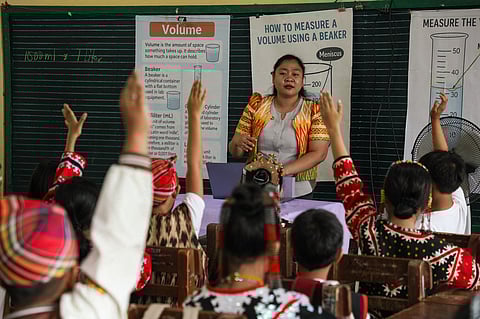 A teacher educating members of an indigenous tribe. 