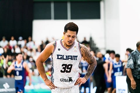 Jericho Cruz of Guam struggles to get past Scottie Thompson of Gilas Pilipinas during their FIBA World Cup Asian Qualifier game late Friday in Guam.