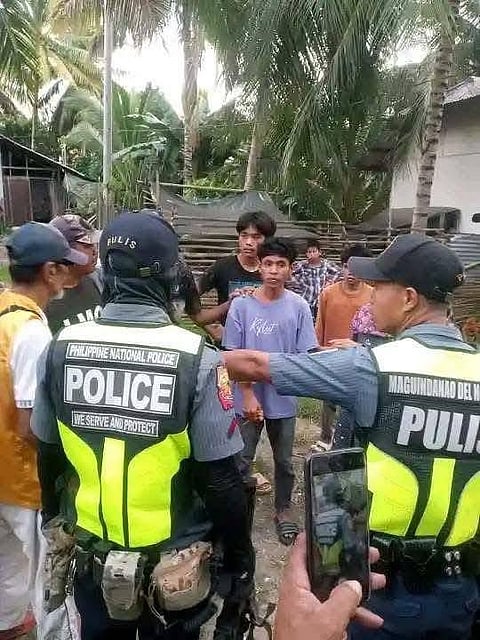 pregnant wife suspect--akmad abag  in gray tshirt was seen here being collared by police on 30 November 2025. The suspect is now in custody of the police, and criminal charges are being prepared. photo courtesy of magnet news fm/via gilbert gorgonio