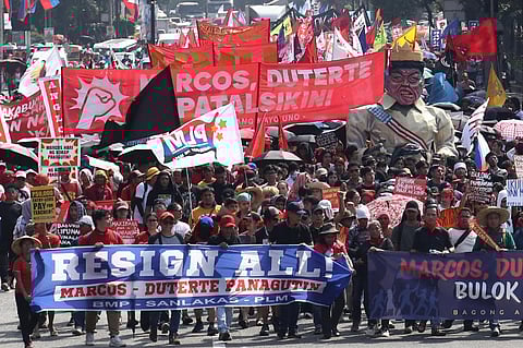 Protestors march towards Mendiola in Manila on 30 November demanding action on massive corruption in the country.