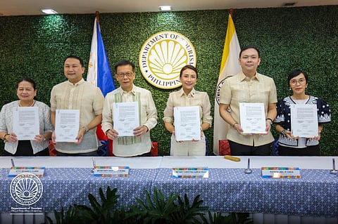 Department of Tourism Secretary (DOT) Christina Garcia Frasco and Department of Migrant Workers (DMW) Secretary Hans Leo Cacdac lead the signing of the memorandum of understanding with executives of Duty Free Philippines, one of the five partner companies of IPON Tourism, on Thursday (Nov. 27) at the DOT Multipurpose Hall in Makati City.
