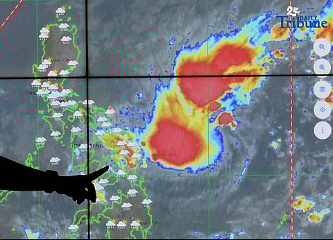 PAGASA hydro forecaster Edgar Dela Cruz points to the location of a low-pressure area east of Eastern Visayas that has developed into a tropical depression named “Wilma,” the state weather bureau announced on Thursday.