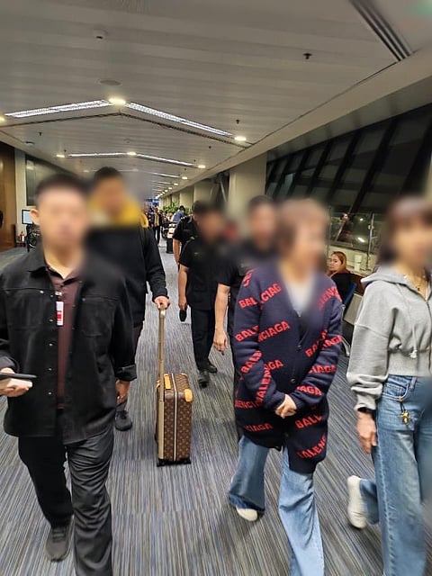 Hao Bin (in black-and-red sweater) at NAIA Terminal 1.