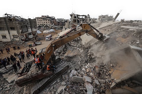 CIVIL defense workers use an excavator to search for the remains of victims in the rubble of a destroyed building in the Bureij refugee camp, in the central Gaza Strip, on 6 December 2025. Qatar and Egypt, guarantors of the Gaza ceasefire, called for the withdrawal of Israeli troops and the deployment of an international stabilization force as the necessary next steps in fully implementing the fragile ceasefire agreement.
