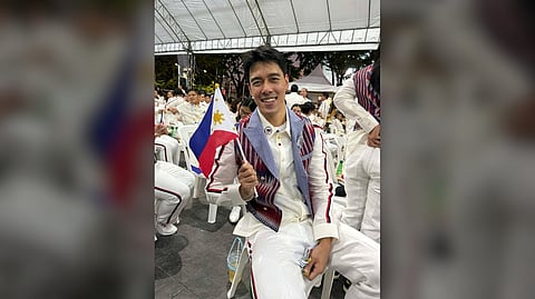 BRYAN Bagunas is honored to carry the national flag during the parade of nations of the 33rd Southeast Asian Games on Tuesday evening at the Rajamangala Stadium in Bangkok. 