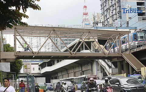 Workers seen at the new build pedestrian-friendly footbridge in Edsa a replacement of controversial bridge Mt. Kamuning on Monday December 8 2025. The footbridge, will be connected to the Edsa Busway station, it is expected to be completed this month. 