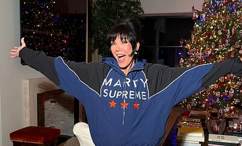 Kris Jenner poses in a blue “Marty Supreme” jacket, subtly showing support for Kylie Jenner and Timothée Chalamet’s relationship ahead of the film’s Christmas Day release. — Kris Jenner/Instagram