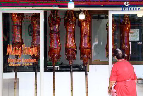 December 10 2025) Workers were seen cooking and displaying roasted pigs or Lechon at their shops in La Loma , Quezon City, on Wednesday December 10 2025, following the recent closure due to the African-swine fever, they are now slowly starting to regain its festive atmosphere. Laloma is the lechon capital of the Philippines. Photo/Analy Labor