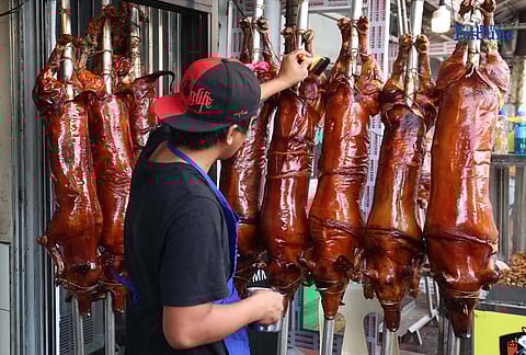 December 10 2025) Workers were seen cooking and displaying roasted pigs or Lechon at their shops in La Loma , Quezon City, on Wednesday December 10 2025, following the recent closure due to the African-swine fever, they are now slowly starting to regain its festive atmosphere. Laloma is the lechon capital of the Philippines. Photo/Analy Labor