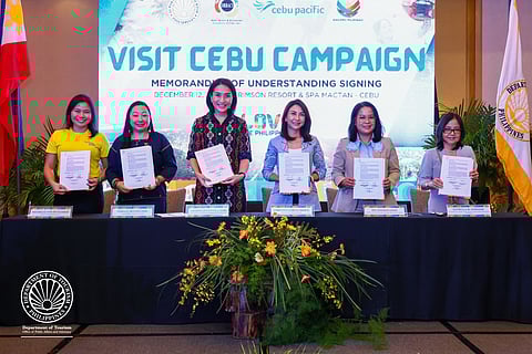 FOR CEBU'S TOURISM BOOST. From left to right: Cebu Pacific Marketing Director Michelle de Guzman, DOT Undersecretary for Tourism Development Verna Buensuceso, Cebu Pacific Chief Marketing and Customer Experience Officer Candice Jennifer Iyog, Department of Tourism (DOT) Secretary Christina Garcia Frasco, HRRAC President Mia Faye-Singson, and HRRAC Vice President for Resorts Estrella Shri. During the ceremonial signing of the Memorandum of Understanding (MOU) for the launch of the “Visit Cebu” campaign in Crimson Resort and Spa Mactan, 12 December 2025.  