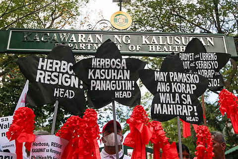 Health advocates stage a symbolic protest using Christmas lanterns outside the Department of Health office in Santa Cruz, Manila on Monday, December 15, 2025, calling for the resignation of Health Secretary Teodoro Herbosa amid alleged anomalies at the agency. The group also pressed for transparency and accountability in the use of the ₱60-billion PhilHealth budget.