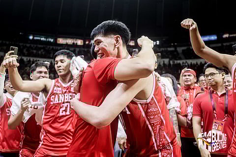 ODDS DEFIED, MISSION ACCOMPLISHED. San Beda Red Lions head coach Yuri Escueta and graduating team captain Yukien Andrada hugging each other after winning their second NCAA championship together. 