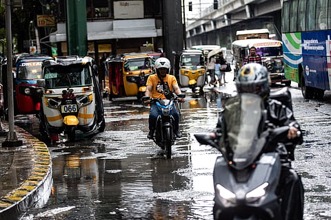 Commuters navigate the streets following a sudden heavy downpour along Taft Avenue in Manila on Tuesday, 16 December 2025. The short but intense rain resulted to some areas being in gutter-deep flood.