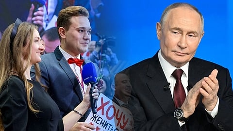 RUSSIAN journalist Kirill Bazhanov holds a placard reading ‘(I) want to get married!’ at President Vladimir Putin’s (inset) annual end-of-year press conference in Moscow on 19 December 2025. 