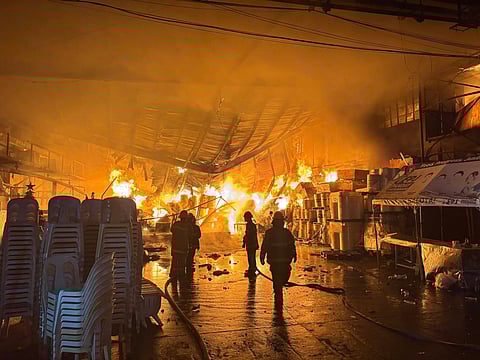FIRE fighters race against time to douse a warehouse fire in Caloocan City that broke out at 4:21 a.m. on Sunday. The fire, fueled by combustible plastic materials, reached a third alarm before being brought under control at 8:50 a.m.