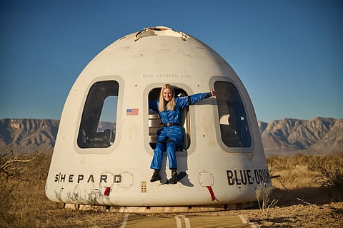 MICHAELA Benthaus poses with the capsule that returned her and other space tourists to Earth. 
