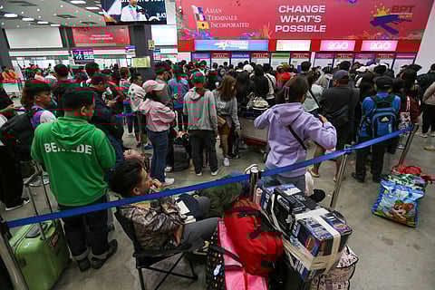 PASSENGERS wait for available trips at Batangas Port as shipping lines grapple with the surge of holiday travelers.