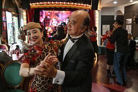 WANG Li (left), 65, dances with a partner at the Hai Shang Jiu Meng Dance Hall in the Changning district of Shanghai, China. 