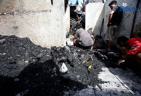 Residents affected by a fifth-alarm fire at Riverside Extension, San Roque Street, Barangay Commonwealth, Quezon City were seen on Monday, December 29, 2025, salvaging reusable belongings from the ruins of their homes. The blaze, which broke out Sunday night, December 28, affected more than 50 houses and displaced around 100 families, or about 500 individuals.