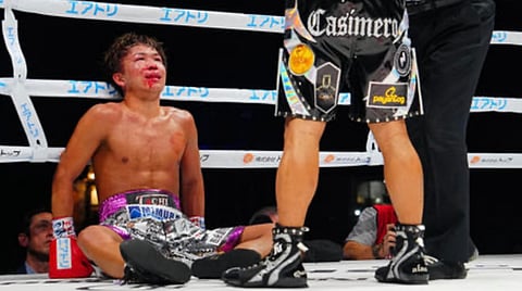 JOHNRIEL Casimero towers over the fallen Japanese Tom Mizokoshi in the fifth round of their featherweight fight on Saturday in Tokoname, Japan.