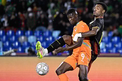 AMAD Diallo and Vakoun Bayo of Ivory Coast try to gain control of the ball during their Africa Cup of Nations game against Cameroon on Sunday. 
