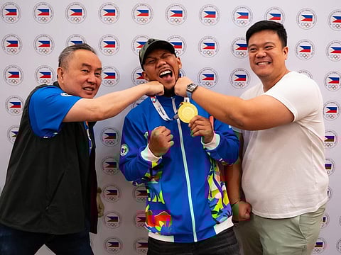 PHILIPPINE Olympic Committee Abraham ‘Bambol Tolentino and secretary general Wharton Chan playfully punch Eumir Marcial after winning the gold medal in the boxing competition of the 33rd SEA Games. 