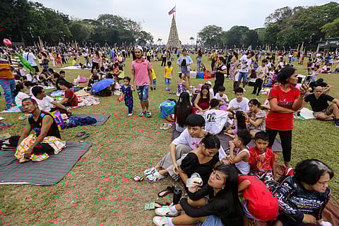 AS the first day of the New Year dawns, families flock the Luneta Park in Manila for relaxation.