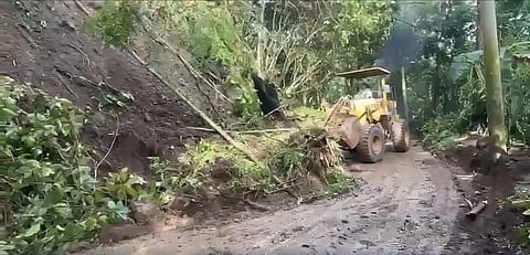 PERSONNEL from the City Engineering Office clear a road hit by a landslide at Sitio Kibanog, Barangay Tignapoloan in Cagayan de Oro on Saturday following heavy rainfall the night before.