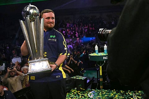 England's Luke Littler poses with the Sid Waddell Trophy after victory over Netherlands' Michael van Gerwen in the PDC World Darts Championship final, at Alexandra Palace in London on January 3, 2025. Luke Littler became darts' youngest world champion at just 17 after thrashing three-time winner Michael van Gerwen in front of an adoring home crowd at London's Alexandra Palace on Friday. This time there was no stopping "Luke the Nuke" as he stormed past Dutchman Van Gerwen by seven sets to three.
