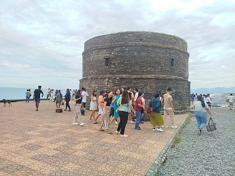 Tourists flock the Baluarte Watchtower, a historic U-shaped coastal fortification built during the Spanish colonial period in Luna, La Union.