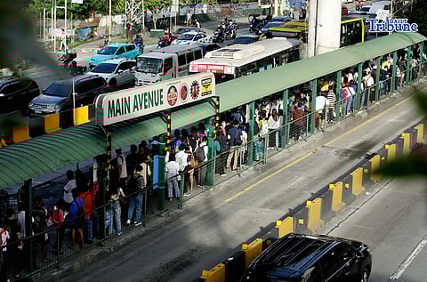 LONG queue of commuters at the EDSA bus carousel Main Avenue station in Quezon City last January 5.