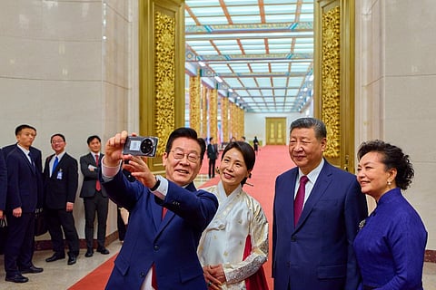 South Korea's President Lee Jae Myung (L) and his wife Kim Hea Kyung (2nd L) take a selfie with China's President Xi Jinping (2nd R) and his wife Peng Liyuan (R) after a dinner at the Great Hall of the People in Beijing on January 5, 2026.
South Korean President Lee Jae Myung snapped a selfie with Xi Jinping using a smartphone gifted to him by the Chinese leader, who had joked at their last meeting that the device might be capable of spying.