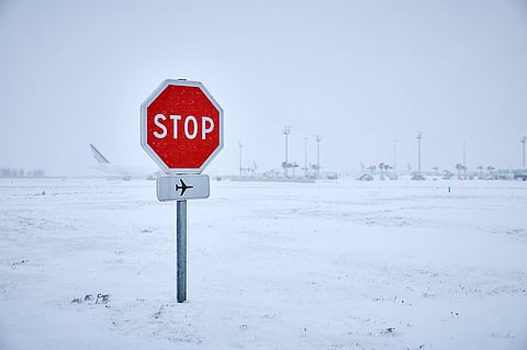 A STOP sign near runways as snow blankets the tarmac, causing flight cancellations at Orly Airport, south of Paris, France on 7 January 2026. Forty percent of flights are expected to be canceled at Paris-Charles-de-Gaulle airport and 25 percent at Orly airport, as snow disrupts air, rail and road traffic across the country. 