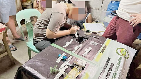 AUTHORITIES check on the seized contraband consisting of illegal drugs and paraphernalia following a sting operation in a drug den in Porac, Pampanga.