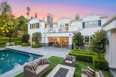 A MODERN mansion with a relaxing pool and a backyard to host family dinners or friend gatherings.