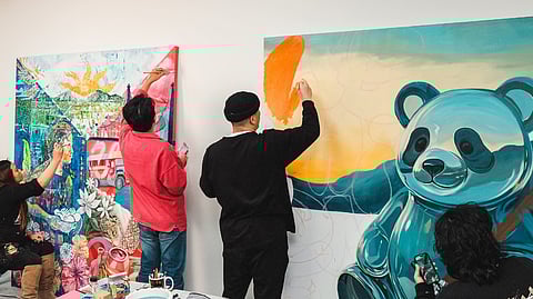 THE artists working on the mural.