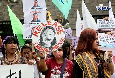 Human rights and migrant rights groups hold a protest outside Camp Aguinaldo in Quezon City on Monday, calling for the immediate release of Filipino-American activist Chantal Anicoche and condemning what they describe as her illegal detention following a reported encounter between government troops and the New People’s Army in Abra de Ilog, Occidental Mindoro, on 1 January.