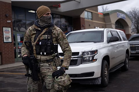 U.S. Border Patrol agents stand watch during a stop at a gas station on January 13, 2026 in Minneapolis, Minnesota. The Trump administration has sent an estimated 2,000 federal agents into the area as they make a push to arrest undocumented immigrants. 