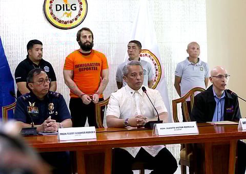 (FILE) DEPARTMENT of the Interior and Local Government Secretary Jonvic Remulla (center) on Thursday speaks to the media following his announcement that Russian vlogger Vitaly Zdorovetskiy will be deported.