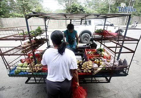 (January 15 2026) A man selling vegetables along Payatas road in Quezon City on 15 January 2026. he uses his tricycle to sell vegetables so they can go to another place. Photo/Analy Labor