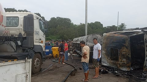 SLICK Responders conduct a siphoning operation along Roman Highway in Barangay Puting Buhangin, Orion, Bataan, on Saturday, extracting remaining fuel from the compartments of an overturned tanker.