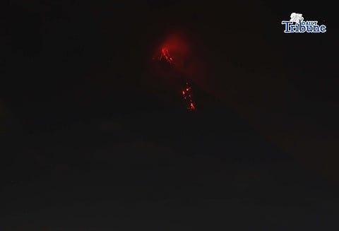 Pyroclastic density currents flow down the slopes of Mayon Volcano as seen from Legazpi City on Sunday night, 18 January 2026.