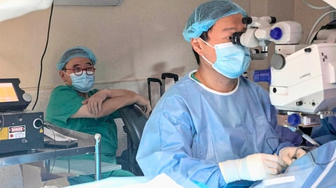 DR. Emil Anthony Say (right) performs a surgery on a patient at the Tzu Chi Eye Center as his father, Dr. Antonio Say watches from behind. 