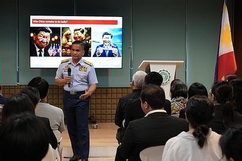 PCG spokesperson Jay Tarriela presents an AI-generated satirical photo of Chinese President Xi Jinping during a forum at De La Salle-College of Saint Benilde earlier this month. China laments this as a 'blatant political provocation' that had 
crossed the red line.'