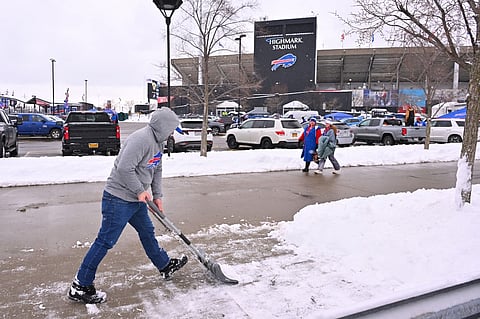 A fan shovels snow before the game between the New York Jets and Buffalo Bills at Highmark Stadium on January 04, 2026 in Orchard Park, New York. Jason 