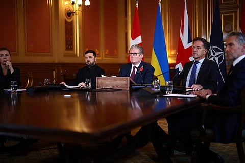 Britain's Prime Minister Keir Starmer (C) flanked by Ukraine's President Volodymyr Zelensky (2L), NATO Secretary-General Mark Rutte (2R), Denmark's Prime Minister Mette Frederiksen (L) and Netherlands Prime Minister Dick Schoof (R) face a screen with other participants joining by video link as he hosts a 'Coalition of the Willing' meeting of international partners on Ukraine at the Foreign, Commonwealth, and Development Office (FCDO) in central London on October 24, 2025. British Prime Minister Keir Starmer told Ukraine's President Volodymyr Zelensky during a meeting in London on Friday that there was more that Western allies could do to bolster Kyiv's long-range missile capability.

