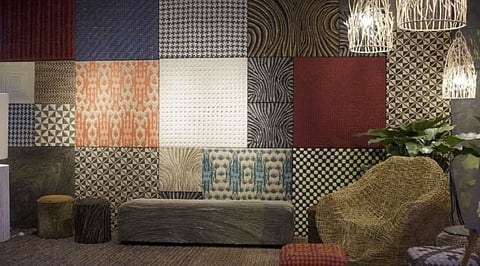 TEXTURED wall panels, chairs and hanging lamps made of natural materials.