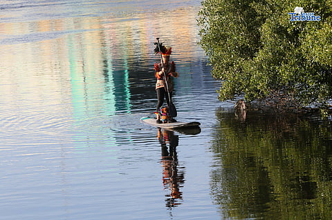 Lucy Lynette Ponce Uygongco, clad in a Dinagyang warrior costume, paddles along the Iloilo River with her dog on the eve of the Dinagyang Festival in Iloilo City, promoting healthy living and a clean river on January 24, 2026.